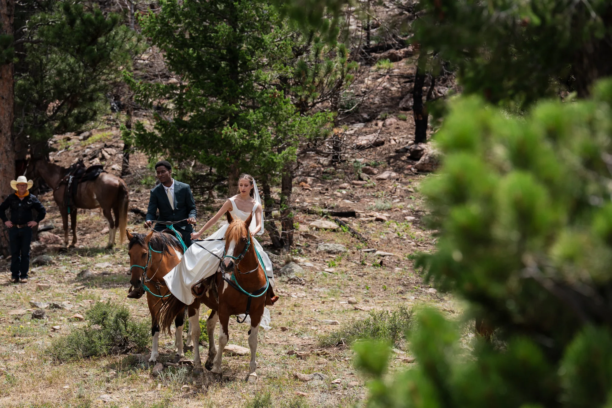 Wedding party riding the trail toward an elopement ceremony overlook in Colorado