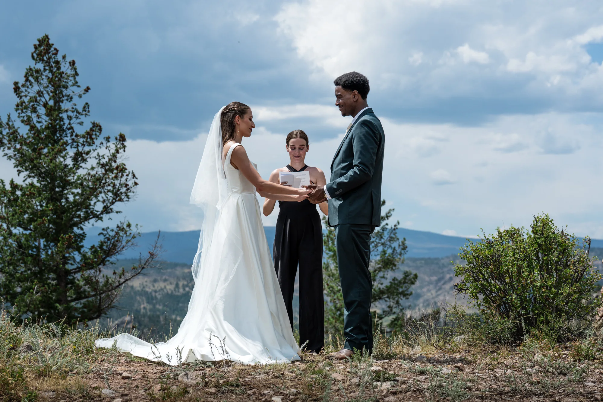 Isabella and Tim exchanging vows at a mountain overlook near Red Feather Lakes, Colorado