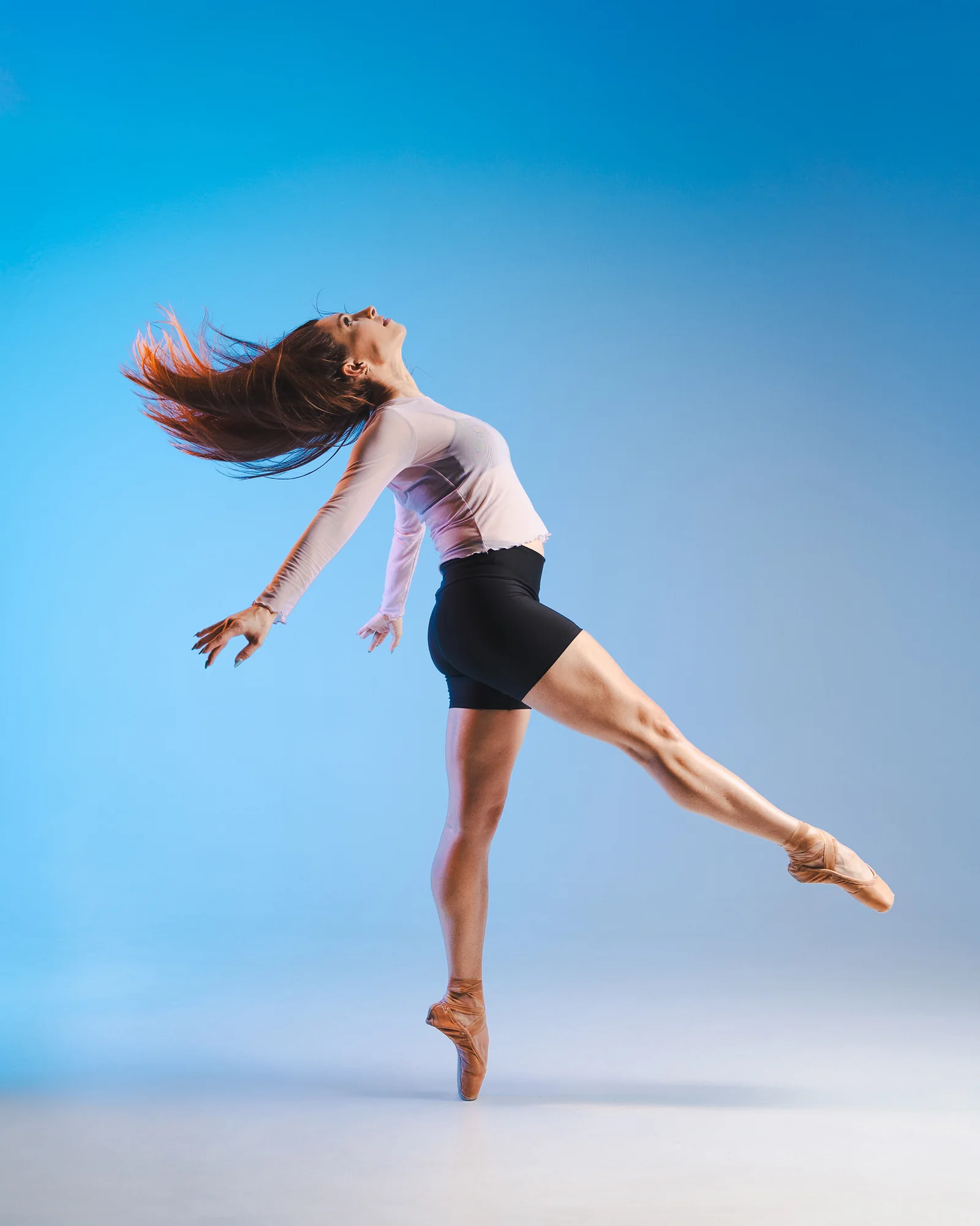 Ballet dancer photographed by Eric Lucky in a dynamic studio movement portrait